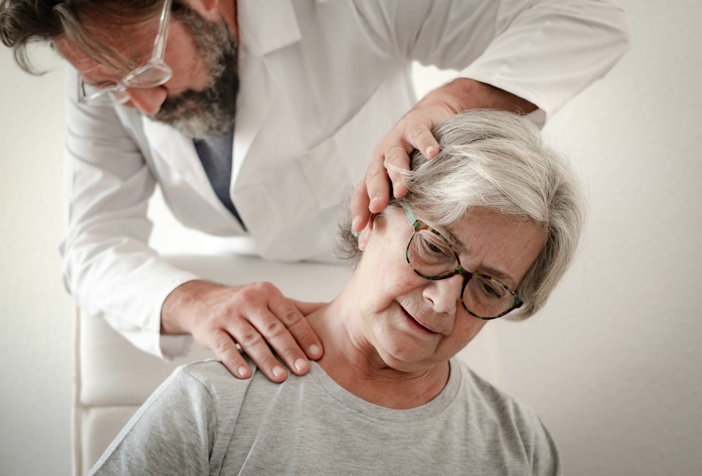 Senior female patient while exercise treatment for neck with his